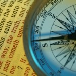 The way to God Spiritual compass. The way to God. Compass pointing south, on top of a bible page.