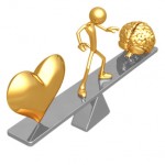 Balance Heart And Mind Gold coloured stick figure, heart, and brain on a teeter totter. Man in the middle, heart on one side, brain on the other.